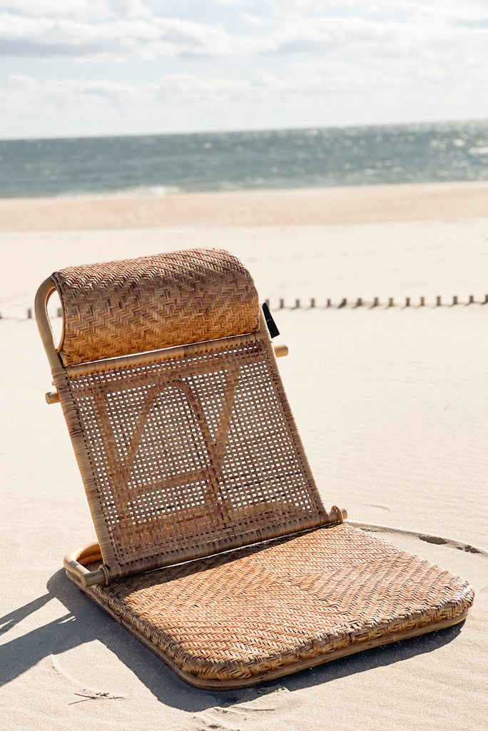 foldable chair on the beach with rattan material
